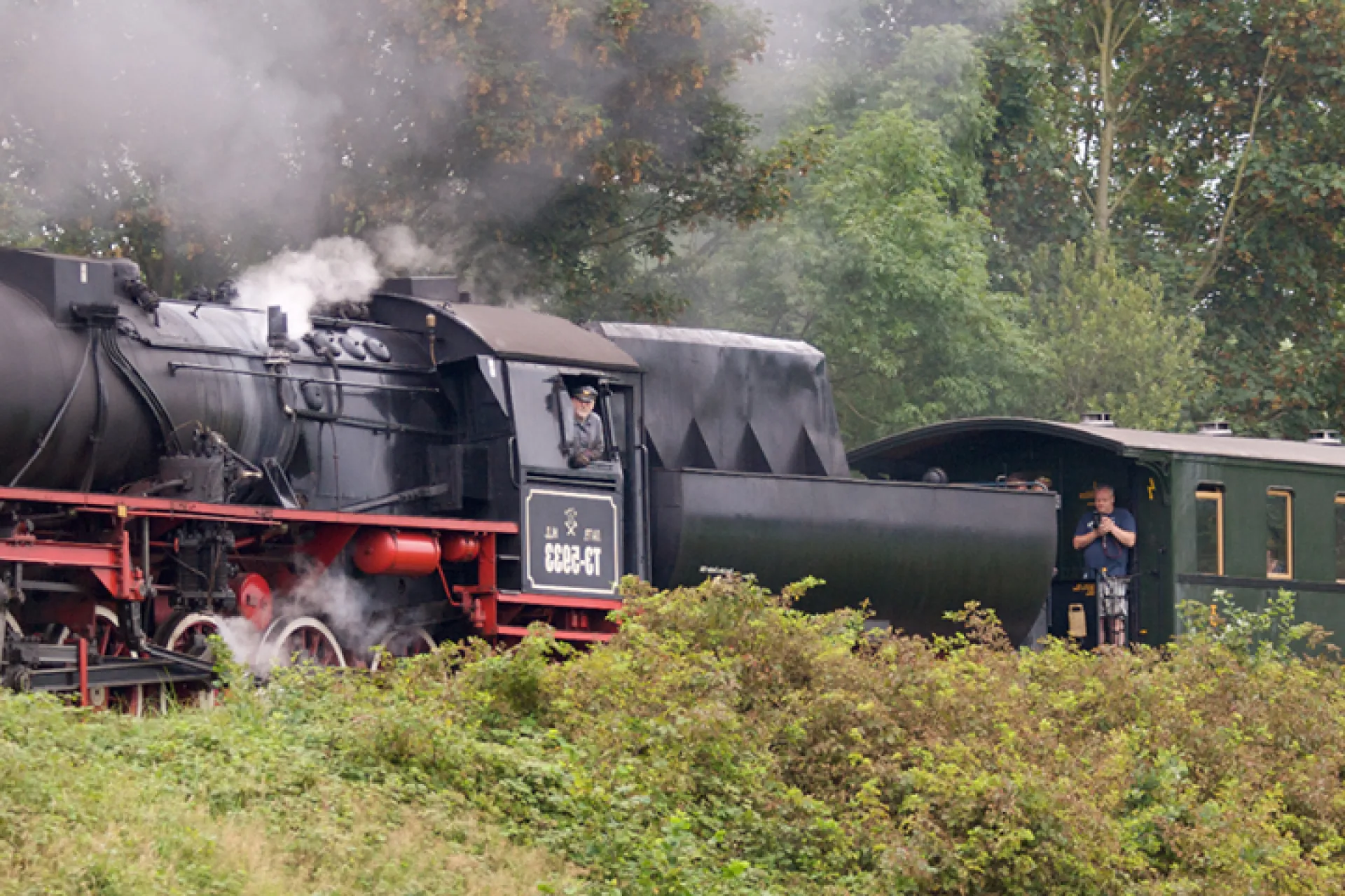 De stoomlocomotief TE-5933 rijdt door het Groninger landschap.